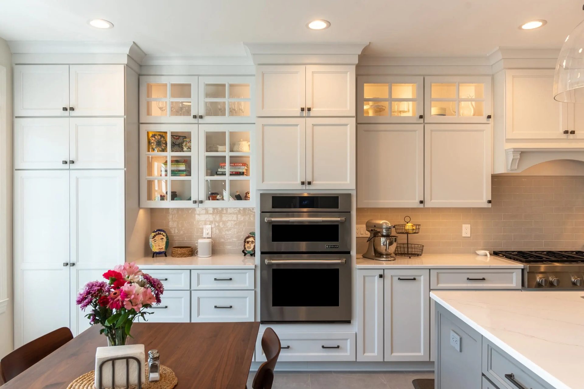 Glass-front display cabinetry with built-in wall oven