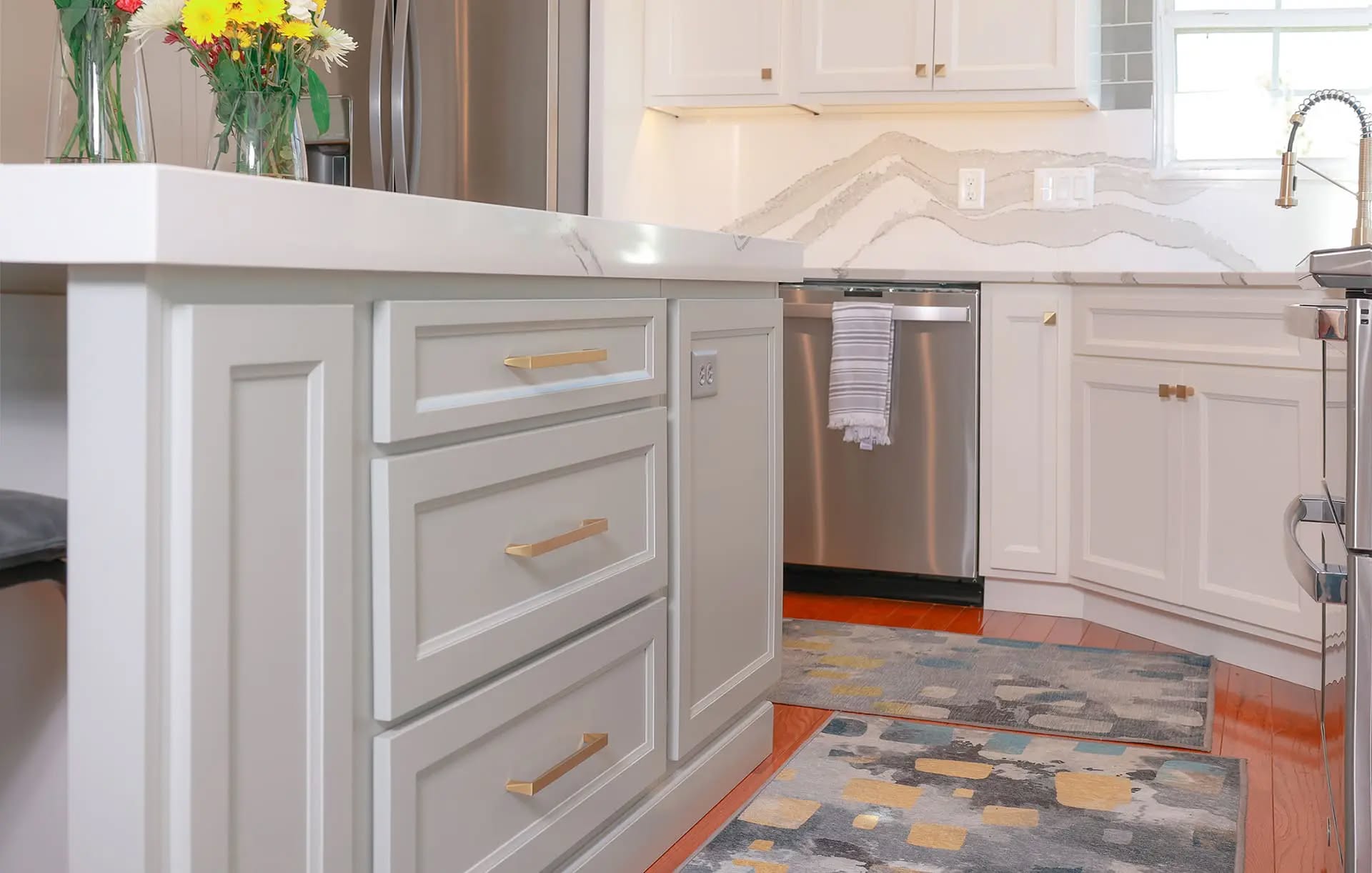 Soft gray cabinetry detail with gold hardware